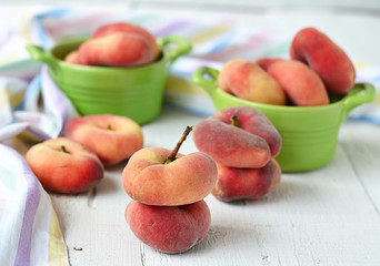 peach figs in a ceramic bowl on a white background