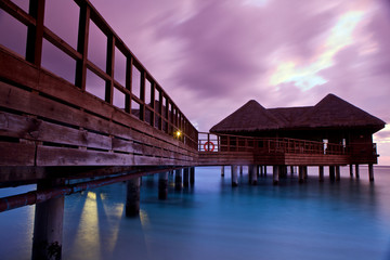 Over water bungalows at sunset.