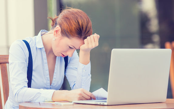 stressed displeased business woman sitting in front of computer