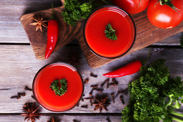 Tomato juice in glasses and fresh vegetables