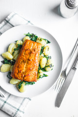 Grilled salmon with gnocchi and greens