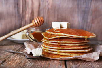 Stack of pancakes with honey and butter