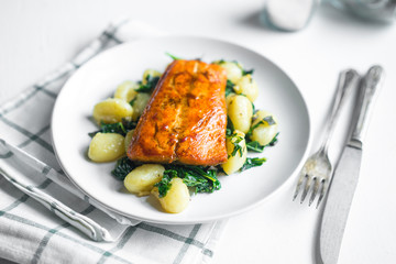 Grilled salmon with gnocchi and greens