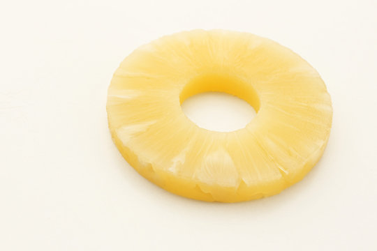 Canned pineapple ring isolated on white