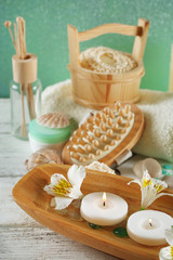 Composition of spa treatment, candles in bowl with water