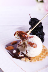 Dessert with prunes and ice cream with chocolate