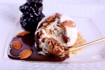 Dessert with prunes and ice cream with chocolate