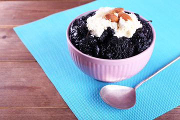 Dessert with prunes and almonds in bowl