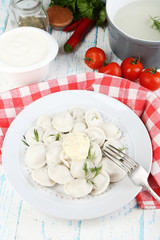 Meat dumplings with sauce on plate on table close-up