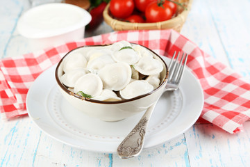 Meat dumplings with sauce on plate on table close-up