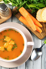 Composition with carrot soup, ingredients and herbs