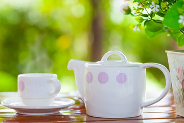 White porcelain set for tea or coffee on wooden table
