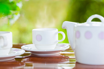 White porcelain set for tea or coffee on wooden table