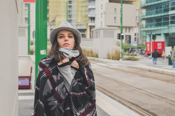 Beautiful young brunette posing in the city streets