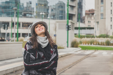 Beautiful young brunette posing in the city streets