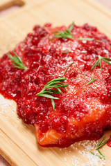 Salmon steak marinated in salt with rosemary and redberries