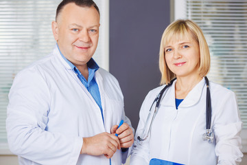 Fototapeta premium Portrait of two happy mature doctors.