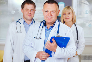 Group of happy doctors looking at camera.