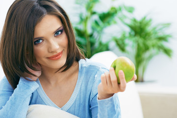 Beautiful young woman hold green apple.