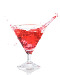 Red cocktail splash in the glass isolated
