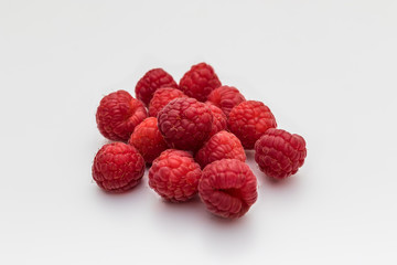 Composition of fresh ripe raspberries isolated on white backgrou