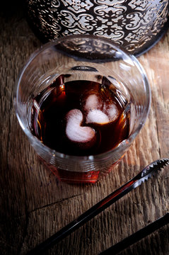 Ice In The Form Of Heart On The Bottom Of The Glass