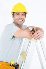 Technician holding pliers while leaning on step ladder