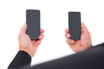 Businessman holding two smart phones