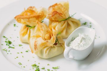 Pancakes with salmon, sour cream and greens
