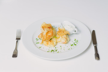 Pancakes with salmon, sour cream and greens