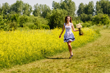 young sexy girl with flowers in the field