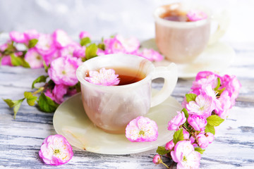 Beautiful fruit blossom with cup of tea