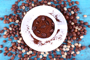 Coffee beans in white ceramic cup with saucer