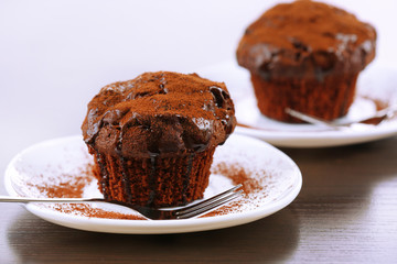 Yummy chocolate cupcake on table