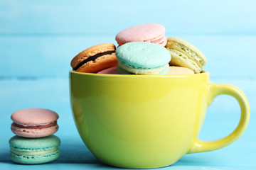 Assortment of gentle colorful macaroons in colorful mug