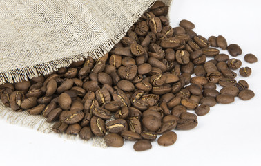 Coffee beans spilled out of the bag. White background. Isolated.