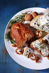 Blue cheese with sprigs of rosemary, bread and nuts