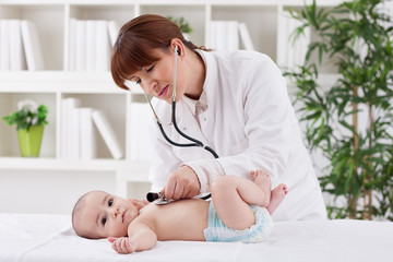 Young doctor female examining a baby patient