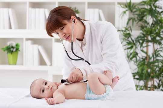 Young Doctor Female Examining A Baby Patient