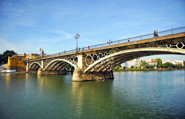 Fototapeta na wymiar Triana bridge and river Guadalquivir, Seville, Spain