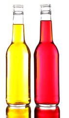 Colorful alcoholic beverages in glass bottles isolated on white