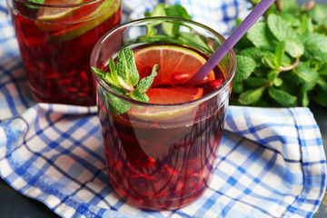 Pomegranate drink in glasses with mint and slices of lime