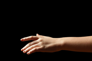 Female hand on dark background