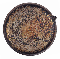 Dirty old frying pan on a white
