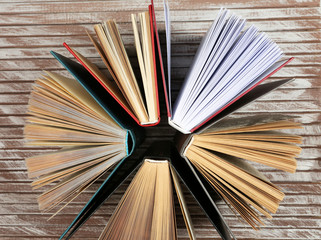 Group of books on wooden planks background, top view