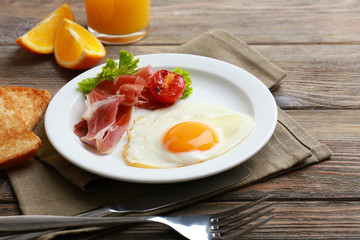Bacon and eggs on rustic wooden planks background
