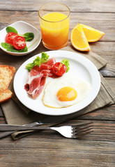 Bacon and eggs on rustic wooden planks background