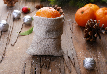 Christmas composition with tangerines on wooden background