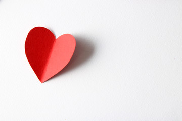 Beautiful paper heart on white paper background, close-up