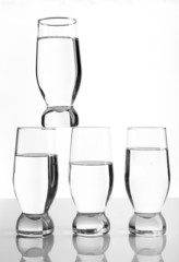 Glasses of water on light background